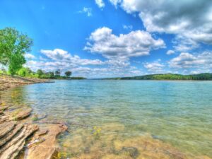 Crystal clear blue water at Norris Lake Tennessee on cloudy sunny day