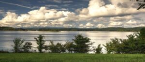 scenic view of Norris Lake from grass shore on cloudy day