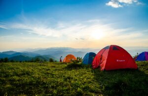 Colorful camping tents on grass with distant view of the smoky mountains near douglas lake