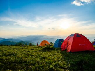 Colorful camping tents on grass with distant view of the smoky mountains near douglas lake
