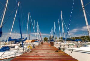 Boat dock with sail boats docked on sunny day